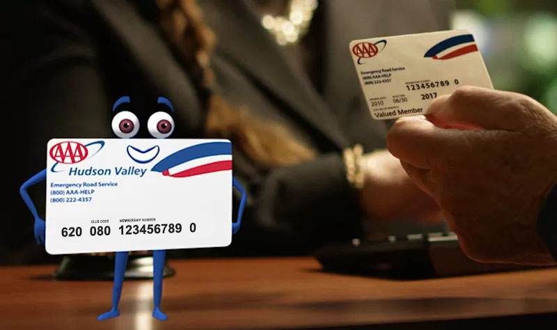 AAA card character on desk in front of man holding AAA member card